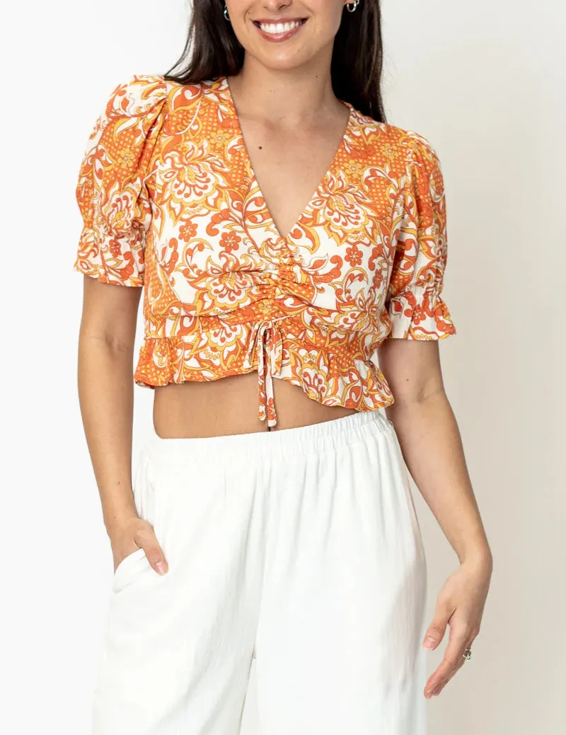 Tali V Neck Front Cinch Printed Top In Orange